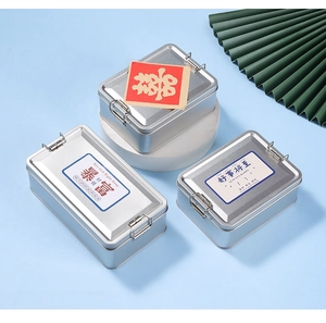 Macro view of vintage silver rectangular tin boxes with metal buckles and stickers
