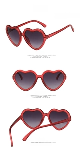 Three-way view of heart-shaped kids sunglasses with red glitter frames and grey lenses