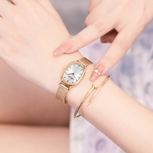 Elegant rose gold oval quartz watch with mesh strap and matching nail cuff bracelet