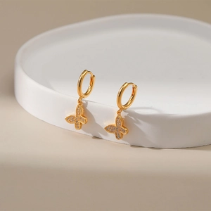 Close-up of gold-plated butterfly earrings featuring zircon micro-pave detailing