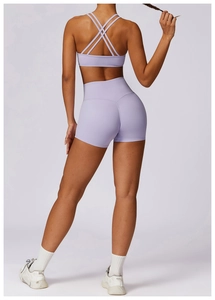 Detail of lavender yoga set featuring cross-strap sports bra and high-waist seamless shorts