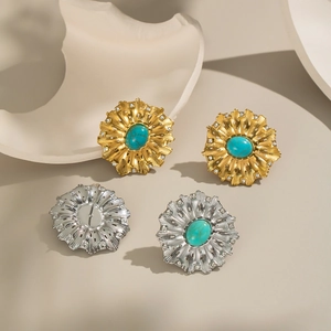 Detail of vintage flower stud earrings with turquoise stones and shimmering crystals