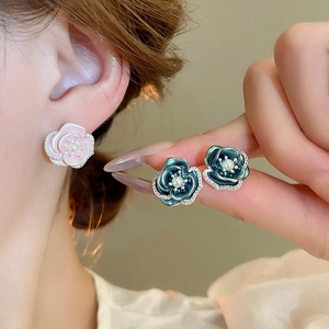 Detail of rose stud earrings with pearls and crystals in pink and dark green