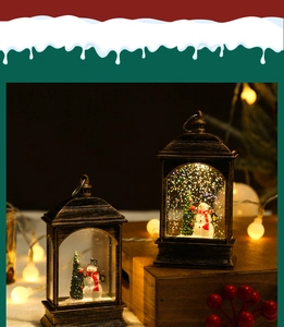 Close-up of bronze Christmas lantern with snowman and glowing interior lights on a wood base