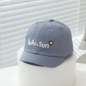 Detail of blue toddler baseball cap with white Hello Sun embroidery and sun icon