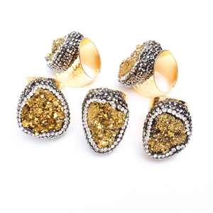 Macro detail of Bohemian crystal druzy rings with gold plating and hammered texture