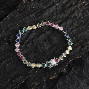 Detail of multi-color heart-shaped cubic zirconia stones in a silver tennis bracelet
