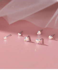 Macro shot of S999 sterling silver heart studs with colorful iridescent zircon details