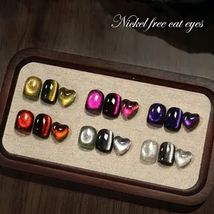 Nickel-free magnetic cat-eye nail polish in gold, silver, and purple hues with glossy finish