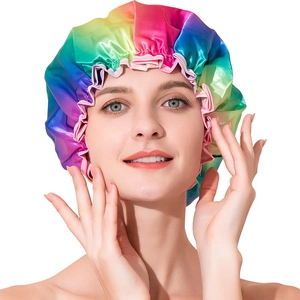 Rainbow satin waterproof shower cap with pink elastic ruffle trim shown on model