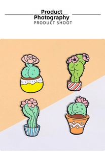 Set of four funny cactus enamel pins with colorful pots and tiny pink flowers
