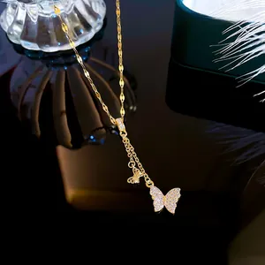 Macro view of crystal butterfly pendant with gold plating on black reflective surface