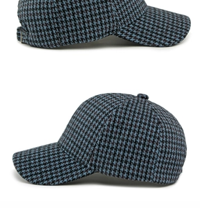 Detail of classic houndstooth wool baseball cap showing blue pattern and metal buckle