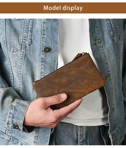 Model holding a vintage dark brown crazy horse leather long wallet with zipper detail