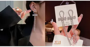 Detail of silver S925 tassel bow earrings with crystal inlay and pearl drop accents