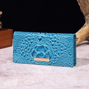 Detail shot of blue crocodile pattern texture on a vintage style long wallet leather