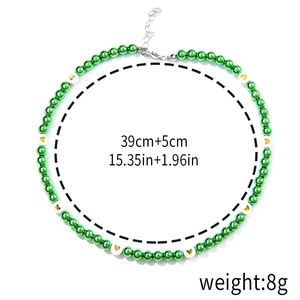 Detail of beaded Christmas necklace with green pearls and gold heart charm dimensions