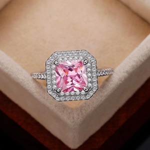 Macro detail of luxury pink princess cut cubic zirconia ring in a plush velvet jewelry box