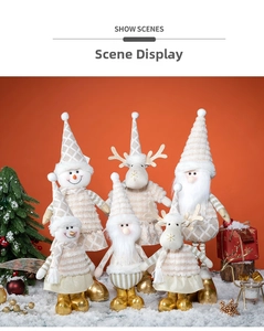 Detail of Santa, snowman, and reindeer plush dolls set in a snowy festive scene