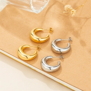 Polished thick C-shaped hoop earrings in gold and silver finish with minimalist design