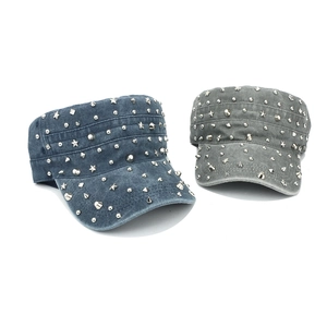 Close-up of vintage cadet caps with silver star studs and punk rivet details