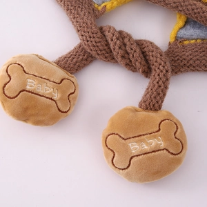 Detail of knitted baby hat with cute plush bone charms featuring Baby embroidery