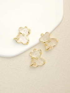 Detailed macro view of three translucent resin bear pendants with gold star accents
