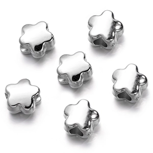 Macro shot of silver metallic flower spacer beads for DIY jewelry making