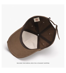 Detail of dark brown canvas baseball cap interior with lining and adjustable strap