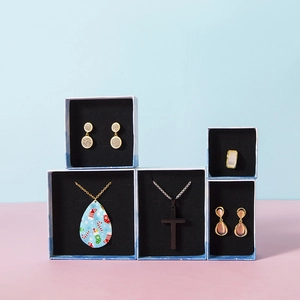 Detailed view of assorted jewelry sets in elegant gift boxes with black padded inserts