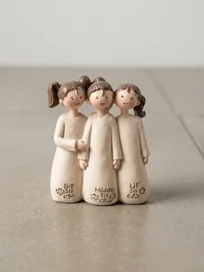 Detailed close-up of three sisters resin statues with Big, Middle, and Lil' Sis engraving