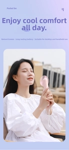 Pink portable pocket fan with white lanyard shown in hand for outdoor cooling