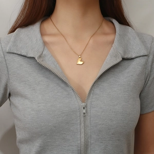 Chic 3D heart necklace in gold titanium steel worn by a model on a clean background