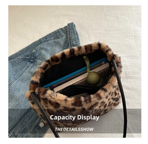 Internal capacity of the leopard print plush tote bag showing essentials like a tablet