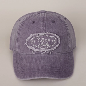 Close-up of vintage washed purple cotton baseball cap with embroidered letter patch