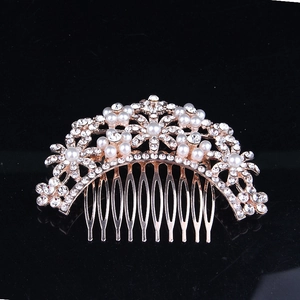 Detailed view of rose gold flower hair comb with shimmering rhinestones and pearls