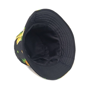 Close-up of black bucket hat with yellow pineapple prints and reinforced stitching details