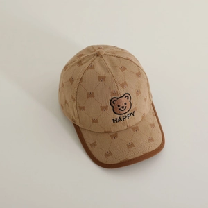 Detail of corduroy baseball cap showing bear embroidery and quilted stitching pattern