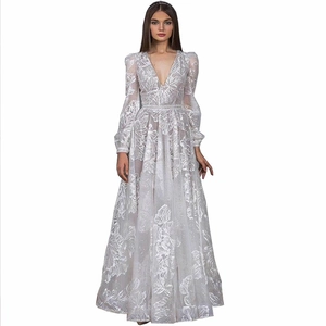 Detail of white evening gown featuring intricate floral embroidery and shimmering sequins