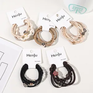Detailed close-up of elastic hair ties set with metal charms and various woven textures