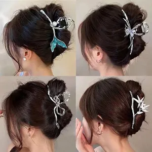 Elegant 4-piece set of silver butterfly and pearl metal hair claws shown on Asian model