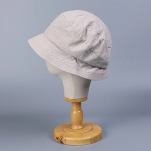 Minimalist beige washed cotton bucket hat for women with detailed stitching and sun protection