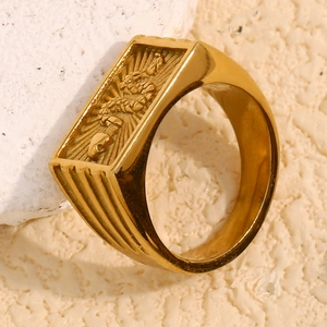 Macro shot of an 18K gold plated stainless steel ring with an embossed snake emblem