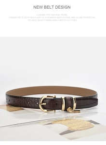Close-up of dark brown crocodile pattern leather belt with a gold buckle on fashion magazines