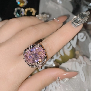 Macro view of a large oval pink gemstone ring with 18k silver-plated decorative setting