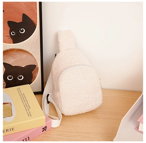 Detail of white teddy fleece kids chest bag showing soft plush texture and zip closure