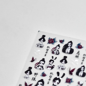 Close-up of Japanese dark gothic nail art stickers featuring fox and rabbit characters
