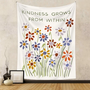 Detail of floral tapestry hanging on grey wall with kindness grows from within text