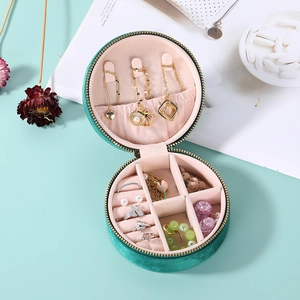 Portable round emerald green velvet jewelry box with multi-compartment storage for rings