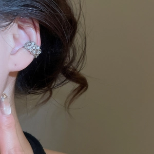 Detailed view of silver zircon floral ear cuff with intricate hollowed-out vintage texture